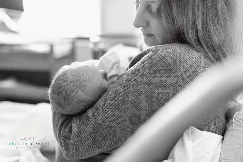 A mom snuggles her newborn during a Fresh 48 hospital session in Iowa City