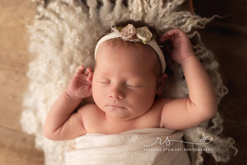 A sweet newborn baby girl sleeps during her Cedar Rapids photography session