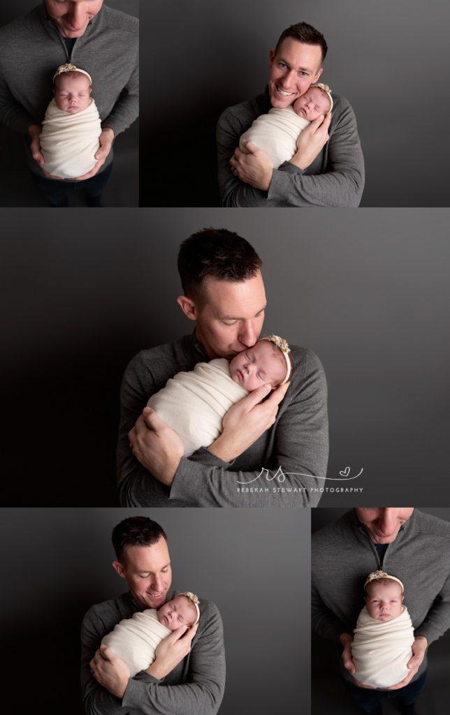 A dad holds his newborn baby girl during her photo session in Cedar Rapids