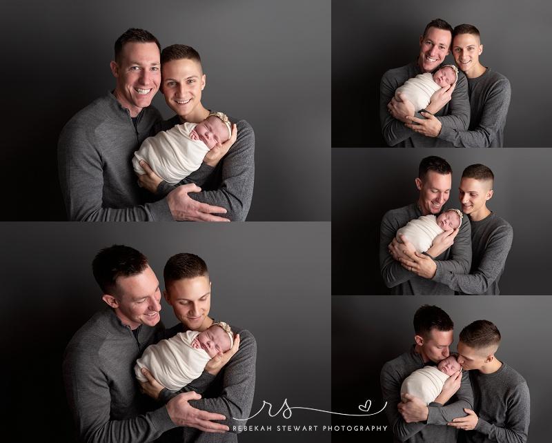 Two dads snuggle their newborn baby girl during her baby photo session in Cedar Rapids, gay dads, adoption