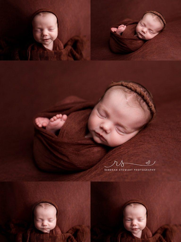 A newborn baby girl sleeps and smiles during her photography session in Cedar Rapids