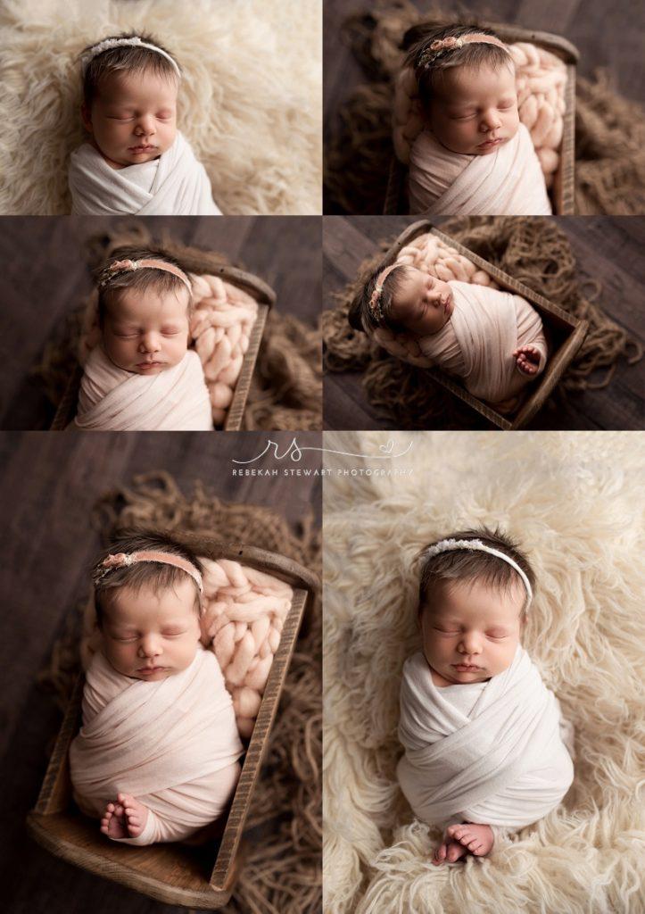 A newborn baby girl is wrapped and sleeps during her photo session in cedar rapids, she has so much hair