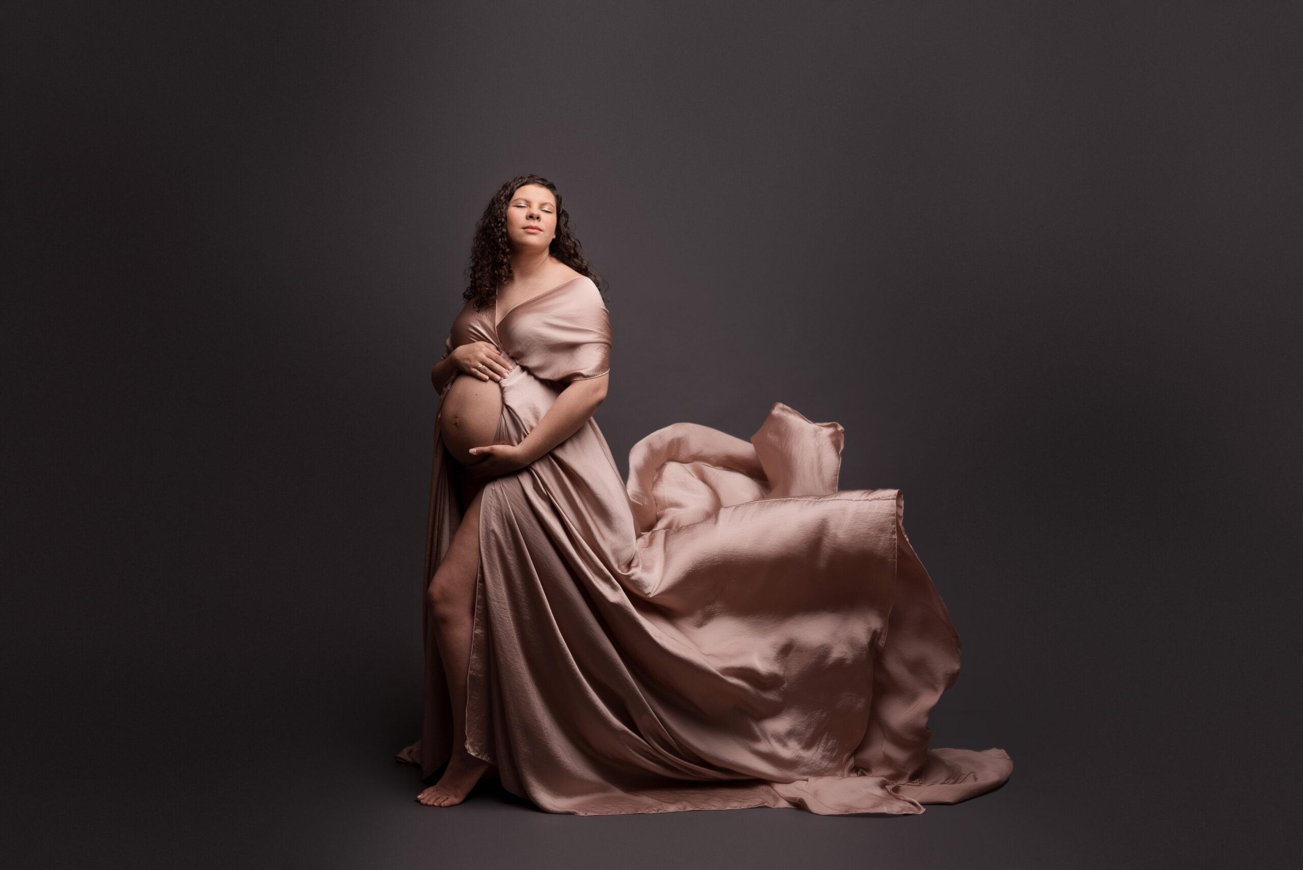 An expecting mom is photographed during her maternity photos session in Cedar Rapids Iowa - baby registry